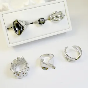 Detailed view of a vintage silver ring set with geometric dark crystals and patterns.