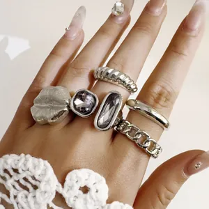 Detailed view of vintage silver ring set with purple gemstones and geometric chain design