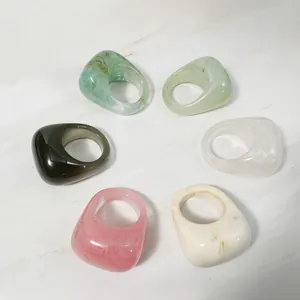 Detailed top view of six colorful chunky acrylic resin rings featuring marble textures