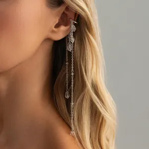 Elegant minimalist silver long tassel ear cuff with sparkling crystal drops on female model