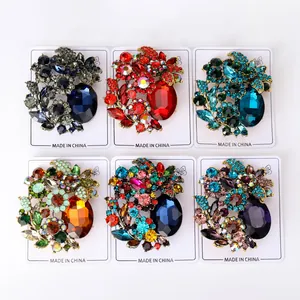 Detailed view of six luxury glass brooches in various vibrant colors on display cards