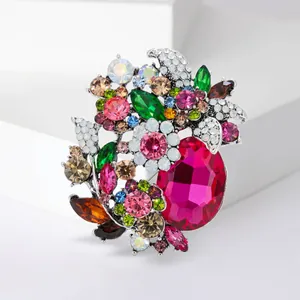 Detailed close-up of an elegant floral brooch featuring vibrant multi-colored crystals.