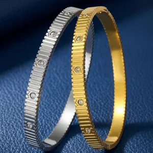 Pair of luxury stainless steel bangles with crystal inlay and ridged texture finish