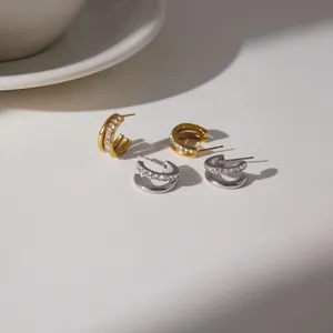 Macro detail view of 18K gold-plated stainless steel hoop earrings with sparkling cubic zirconia