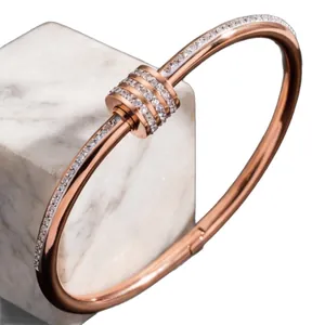 Rose gold stainless steel bangle with sparkling stone-set slider rings