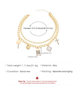 Detail view of gold multi-layer necklace with lock and clover charms and size specs