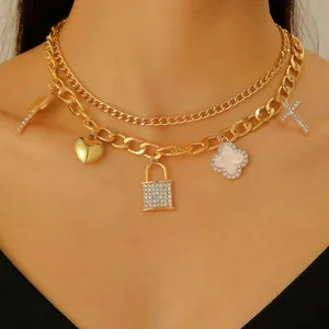 Close-up of gold multi-layer punk necklace with heart, lock, and cross pendants