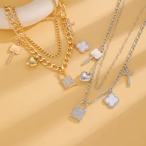 Close-up of gold and silver 3-layer punk necklaces with lock and heart charms.