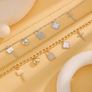 Close-up of elegant gold and silver layered necklaces with paved lock and heart charms