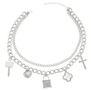 Detail view of silver triple-layered necklace with lock and clover charms