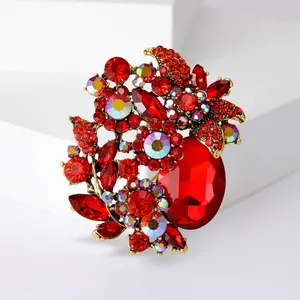 Close-up of elegant red glass floral brooch with sparkling crystal rhinestones for women