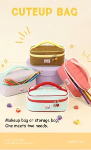 Detail view of macaron color-contrast makeup bags with portable handles and charms