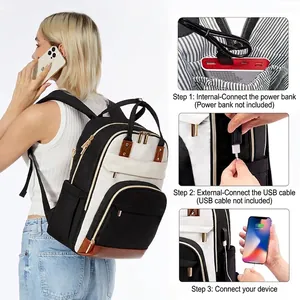 Detail view showing integrated USB charging port on fashionable black and white laptop backpack.