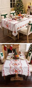 Festive Christmas tablecloth with red poinsettia embroidery in a cozy dining room
