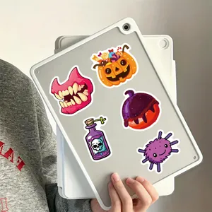 Detailed view of cute Halloween stickers on a tablet back with pumpkin and monster motifs.