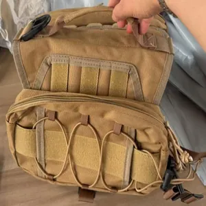 Close-up detail of a khaki tactical dog saddlebag featuring MOLLE webbing and a top handle.