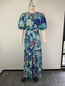 Front view of vibrant floral print maxi dress with puff sleeves on mannequin.