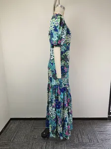 Detailed side view of an elegant floral print maxi dress featuring stylish puff sleeves