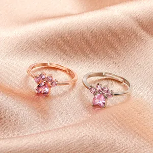 Exquisite rose gold and silver cat paw rings with pink heart stones on luxury satin