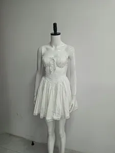 Detailed front view of a white lace-trimmed mini dress displayed on a mannequin
