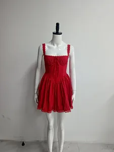 Front view of a red mini strap dress with lace trim and bow on a white mannequin