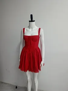 Detail view of red sleeveless mini dress featuring lace trim and a flattering corset bodice