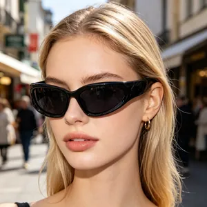 Close-up of stylish black cat-eye cycling sunglasses worn by a blonde female model outdoors