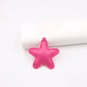 Detailed macro view of a pink padded star leather charm featuring refined stitching