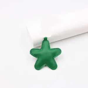 Close-up view of a green 3D padded leather star charm with detailed stitched edges
