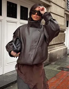 Detail shot showing the rich brown lychee texture of this vintage oversized leather jacket