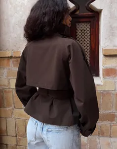 Back view of a stylish brown short trench coat featuring a belted waist design.