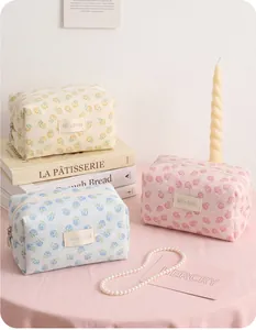 Three elegant floral mesh jacquard makeup bags in cream, pink and blue pastel tones
