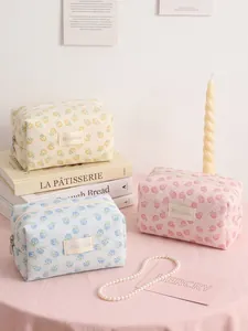 Elegant floral jacquard mesh makeup pouches for travel storage in pink, blue, and yellow
