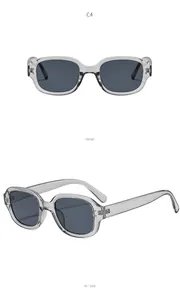 Detail view of oval sunglasses with transparent grey frame and dark lenses at 45 degree.