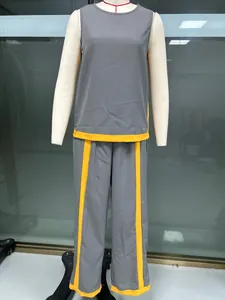 Detail of grey and yellow contrast sleeveless two-piece set with wide-leg pants on mannequin
