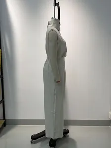 Side view of a women's beige cotton-linen sleeveless top and wide-leg trousers set