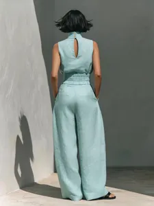 Back view of a sleeveless cotton-linen top and wide-leg pants set in mint blue