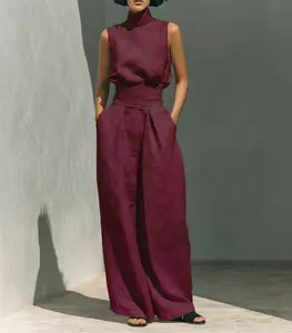 Full body shot of a model wearing a burgundy cotton-linen set in a sunny outdoor setting