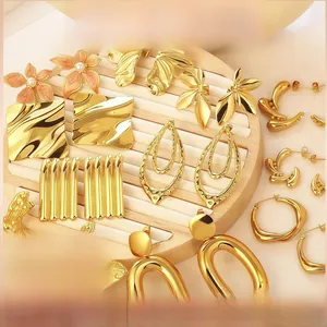 Exaggerated gold-plated geometric earring collection showcased on a wooden jewelry stand