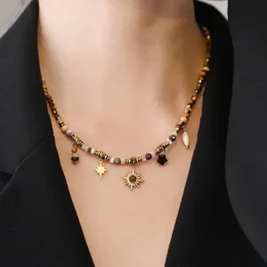 Detailed view of a Bohemian beaded necklace featuring sun and star pendants worn on neck