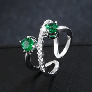 Elegant silver crossover open ring with emerald green zirconia stones for women