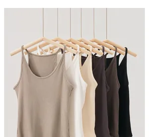 Close-up detail of women's ribbed camisole tops in multiple colors on wooden hangers