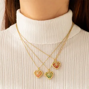Gold plated heart locket necklaces with colorful stones on a white sweater background