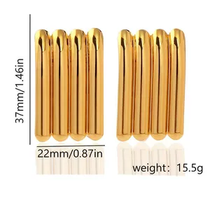 Close-up detail of geometric gold plated earrings showing dimensions and 15.5g weight