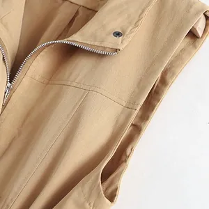 Detailed macro view of khaki casual vest showing metal zipper and snap button closure