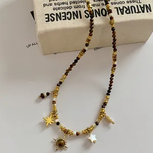 Bohemian Maillard style necklace with tiger eye beads and sun star pendants.