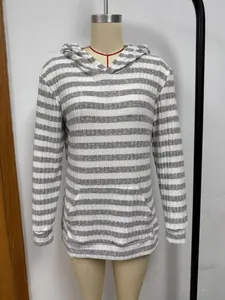 Close-up view of front kangaroo pocket on a grey and white striped casual hoodie