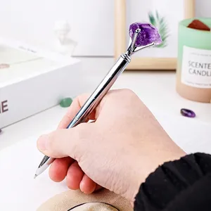 Professional silver metal ballpoint pen topped with a raw purple amethyst crystal point
