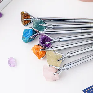 Elegant silver metal ballpoint pens featuring natural raw crystal stone tops, creative design.