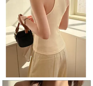 Detailed back view of a minimalist beige ribbed knit tank top for women in sunlight